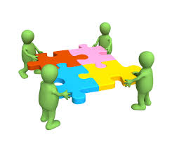 Cartoon image with 4 green people shapes each holding a different colored puzzle piece.